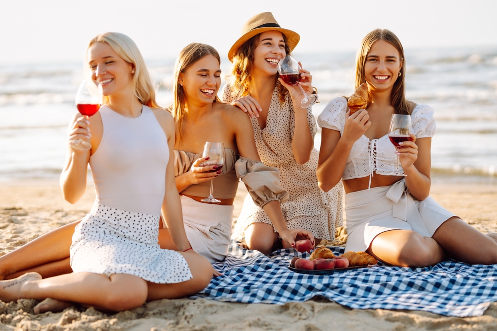 Girls weekend away, picnic and drinks on the beach.