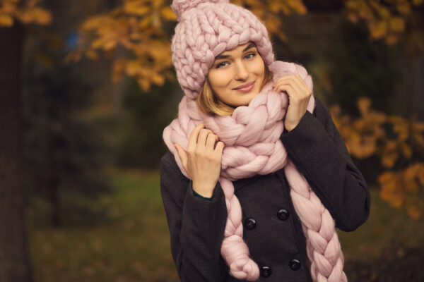 Girl in winter wearing knitted beanie and scarf.