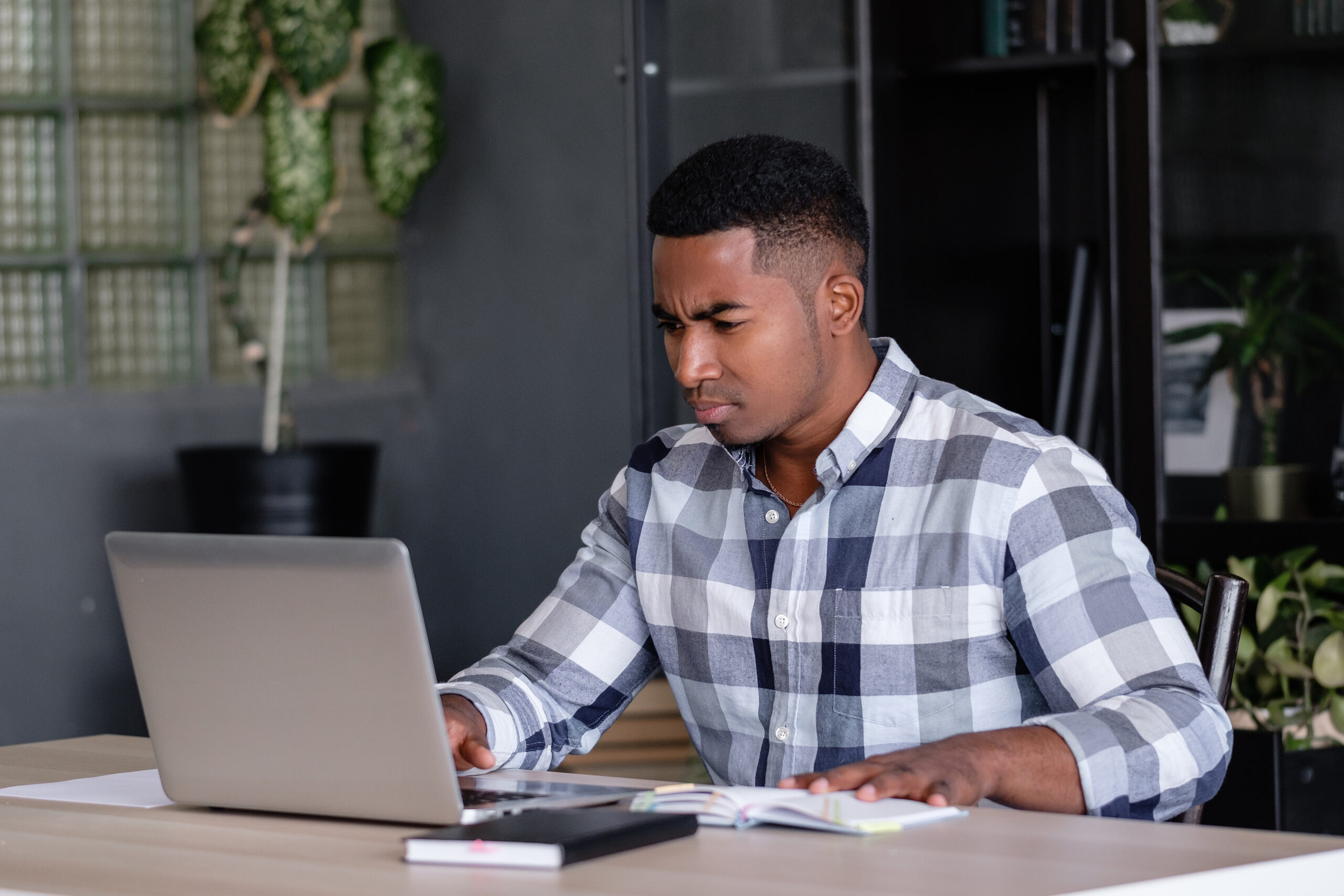 serious man looking at laptop