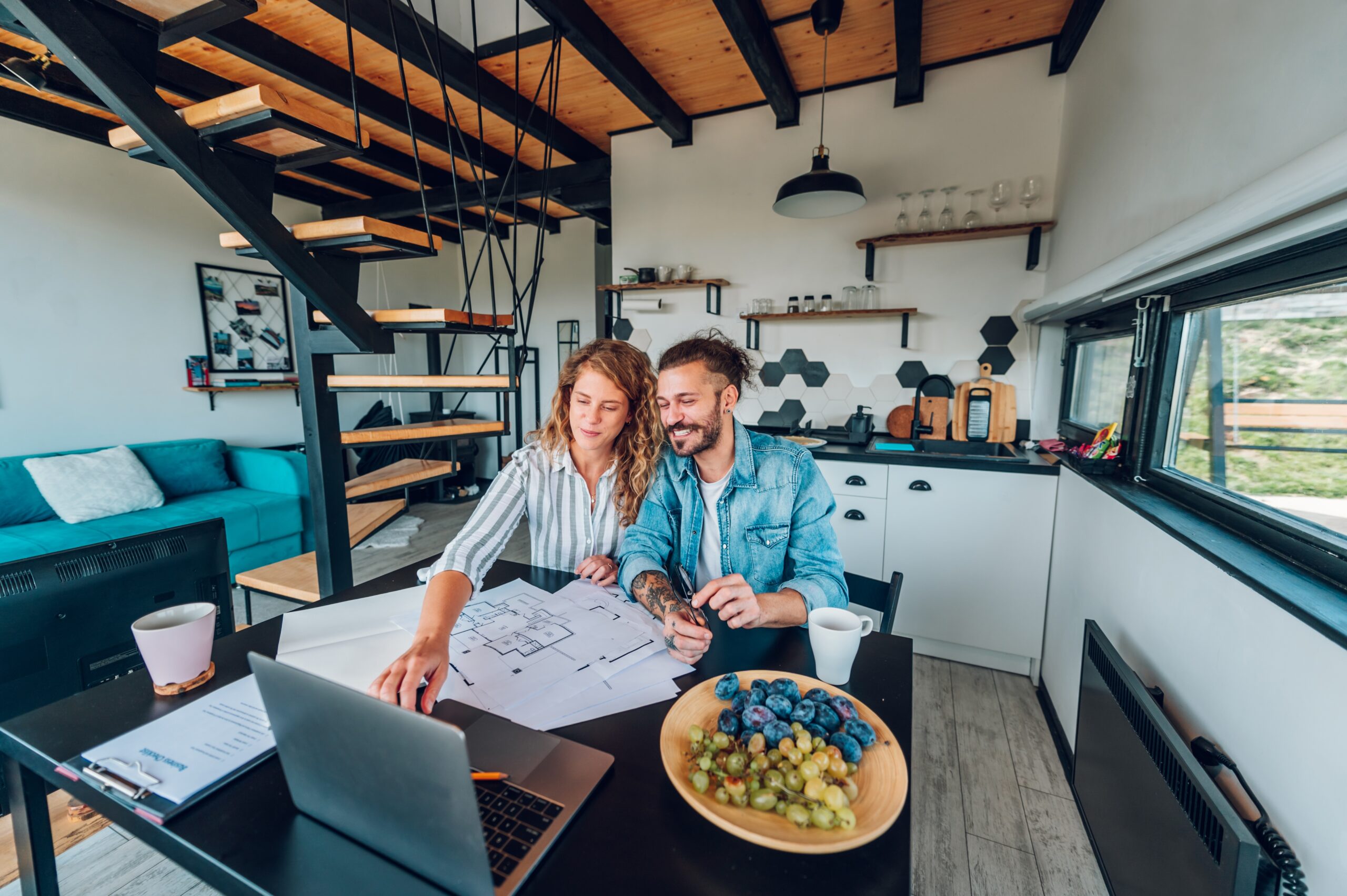 couple working on a laptop floor plan house