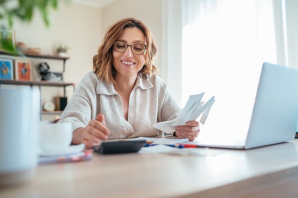 middle aged woman saving money bills finance papers