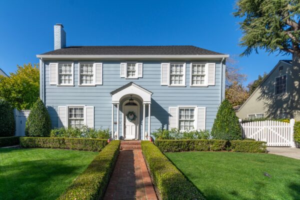 large home in the suburbs lawn blue house