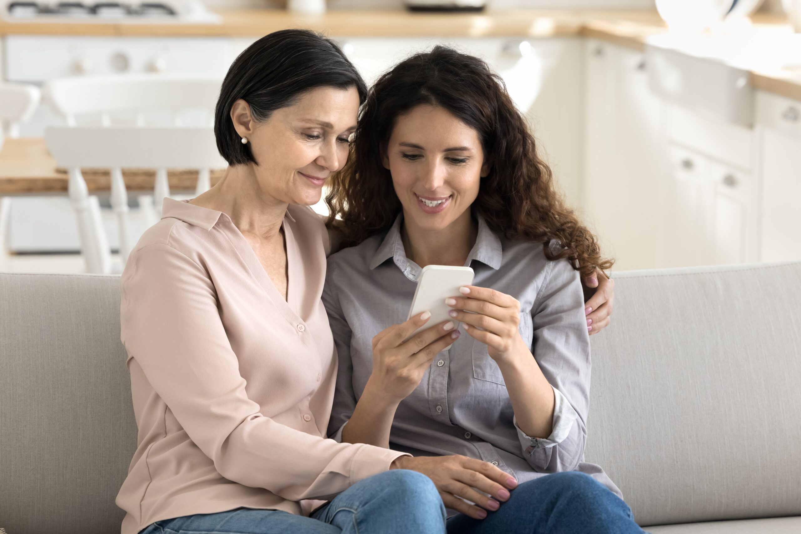 older mom and daughter looking at phone